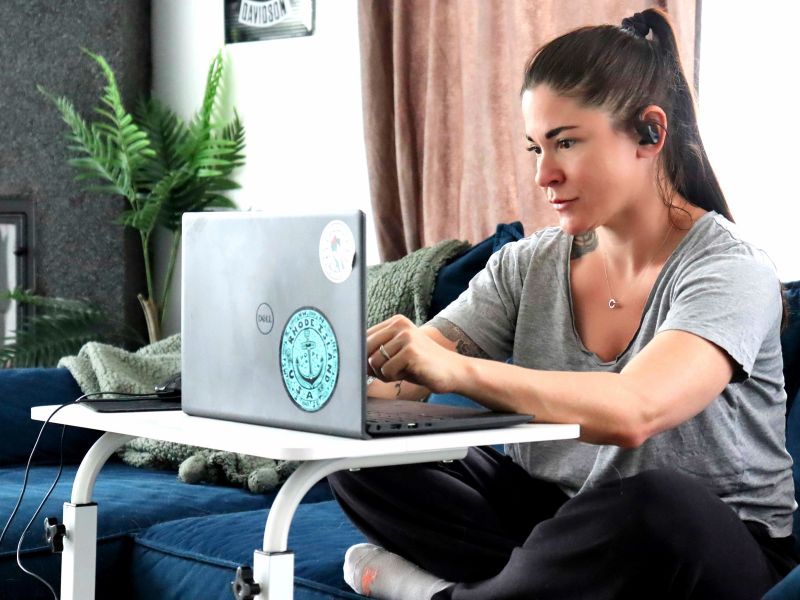 Woman working at laptop in her livingroom