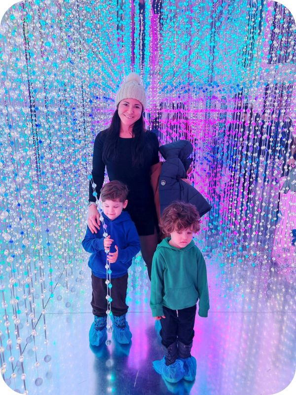 Mom and two kids in a bright dreamlike holographic room.