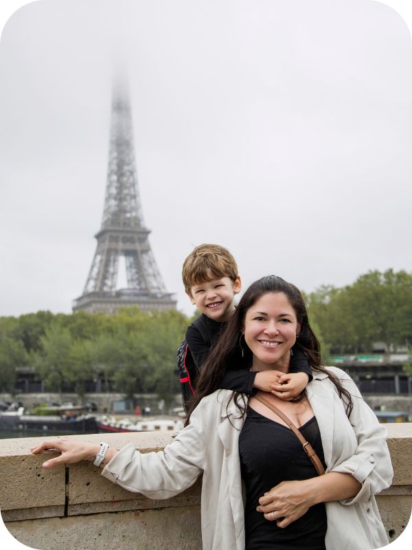 Woman and her son in front of the Eiffel Tower from Bir Hakeim bridge.